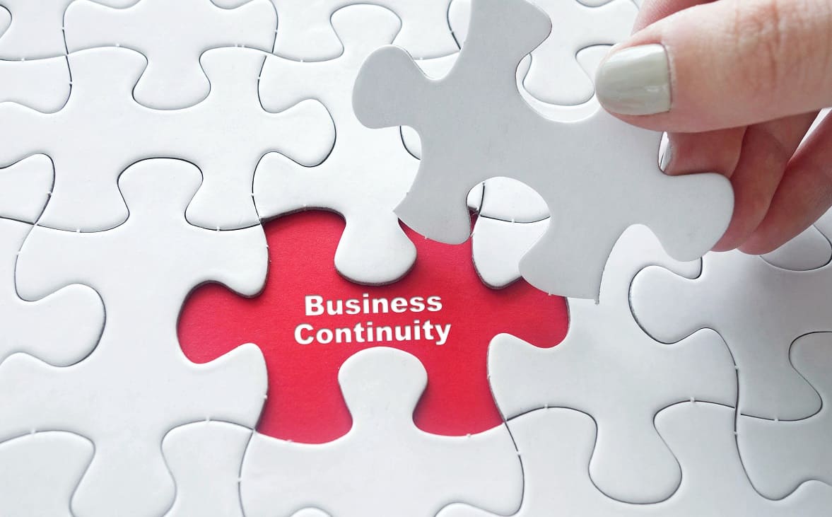 White and red jigsaw spelling out business continuity