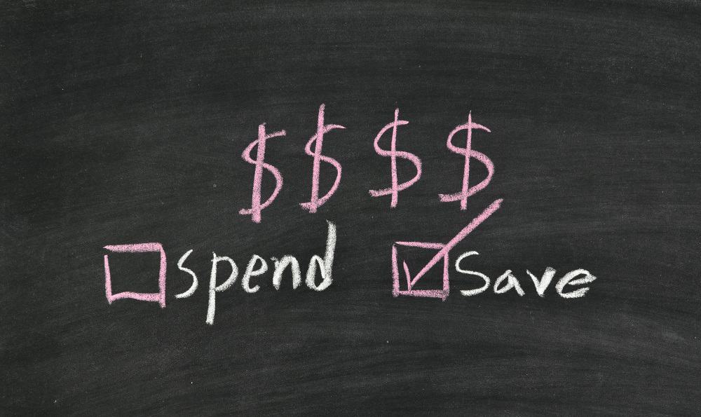 Blackboard with dollar signs and tick boxes saying spend and save