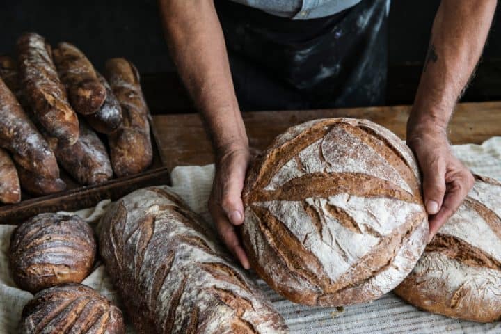 Hands on loaves of bread