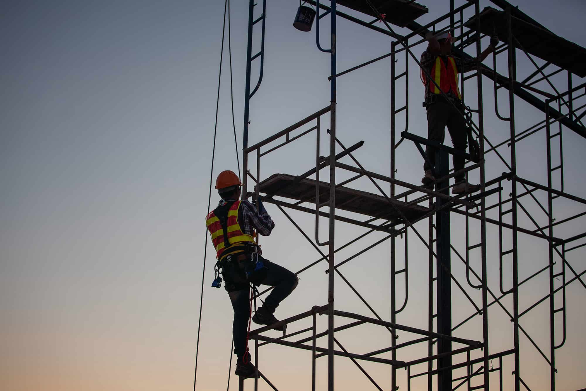 Man climbing up scaffolding
