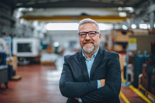 Portrait of Smiling Senior Manager Businessman in Industrial Factory