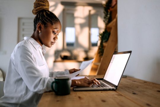 Concentrated businesswoman in professional attire working from home