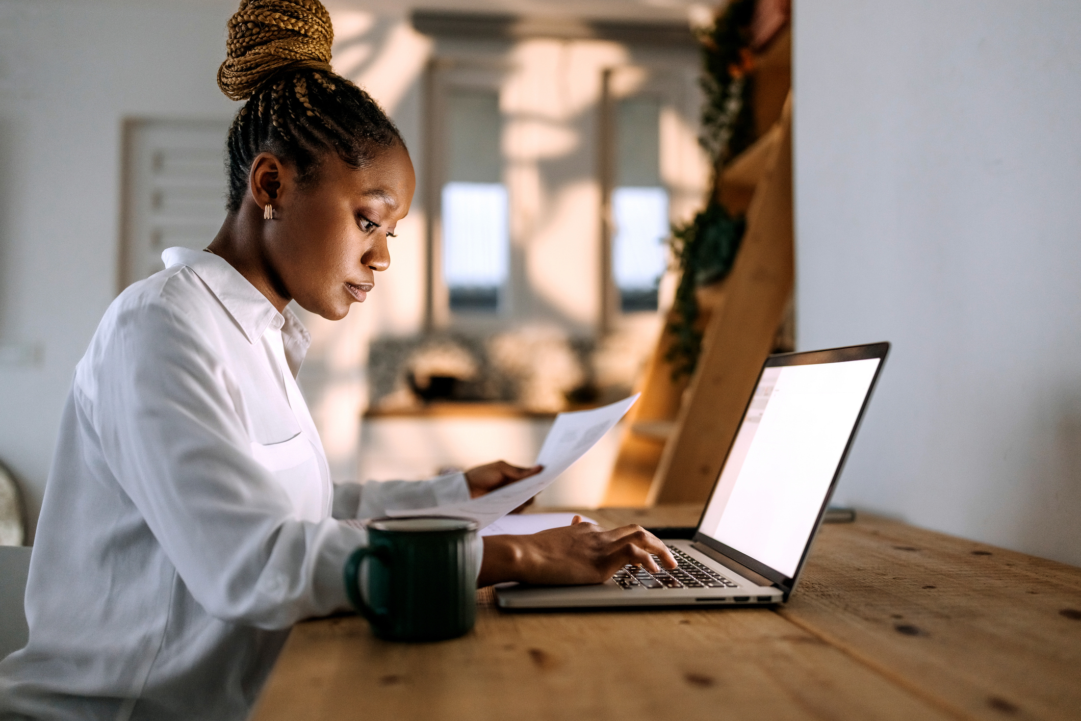 Concentrated businesswoman in professional attire working from home