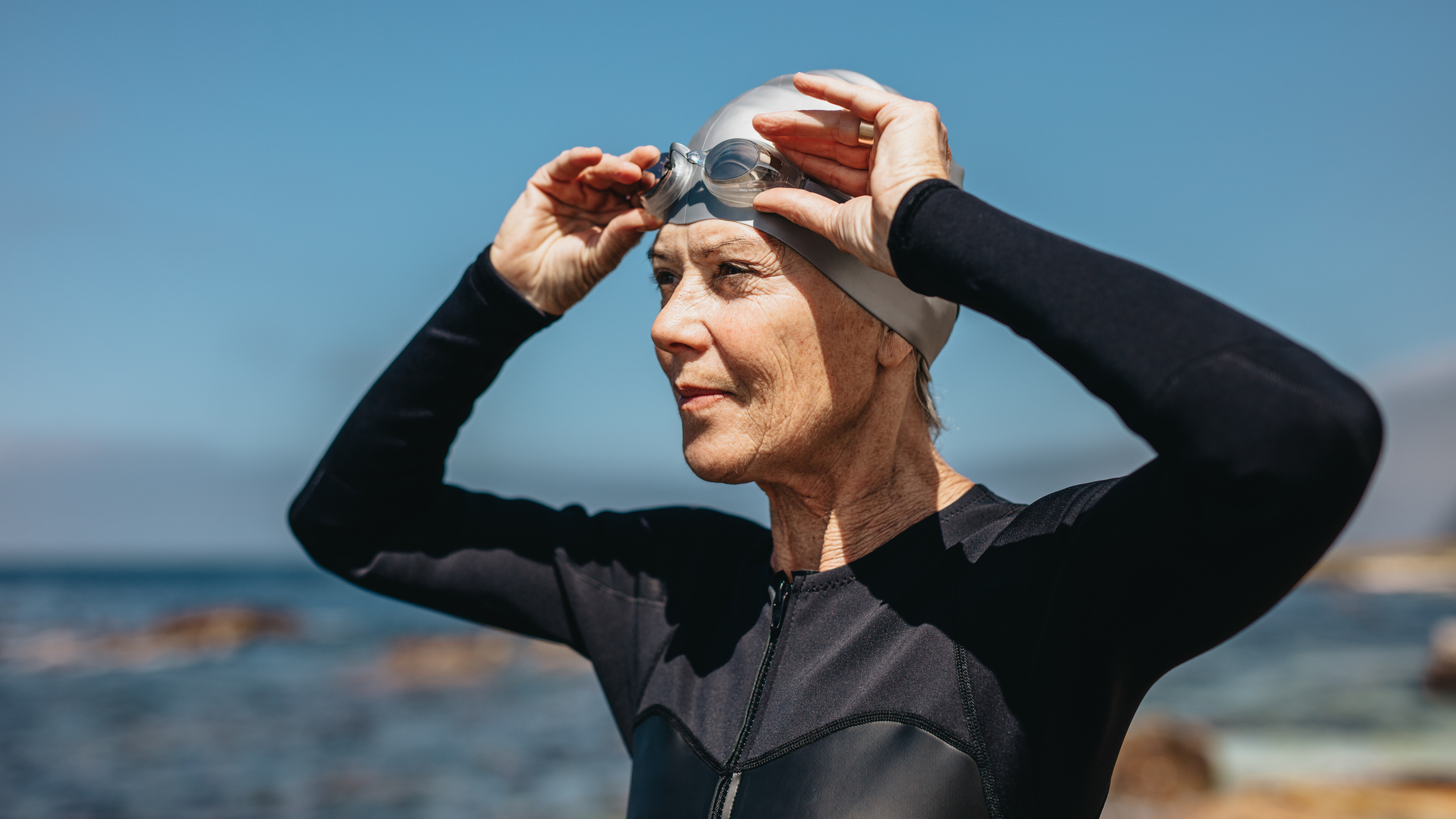 Female swimmer standing on the beach
