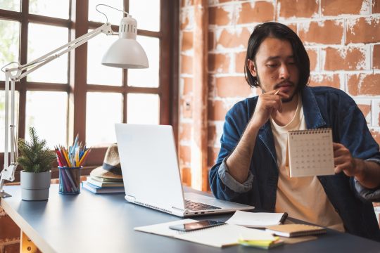 Young Asian man working on laptop for business creative designer