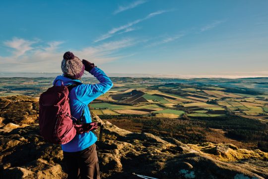 Female hiker at the summit of Bennachie