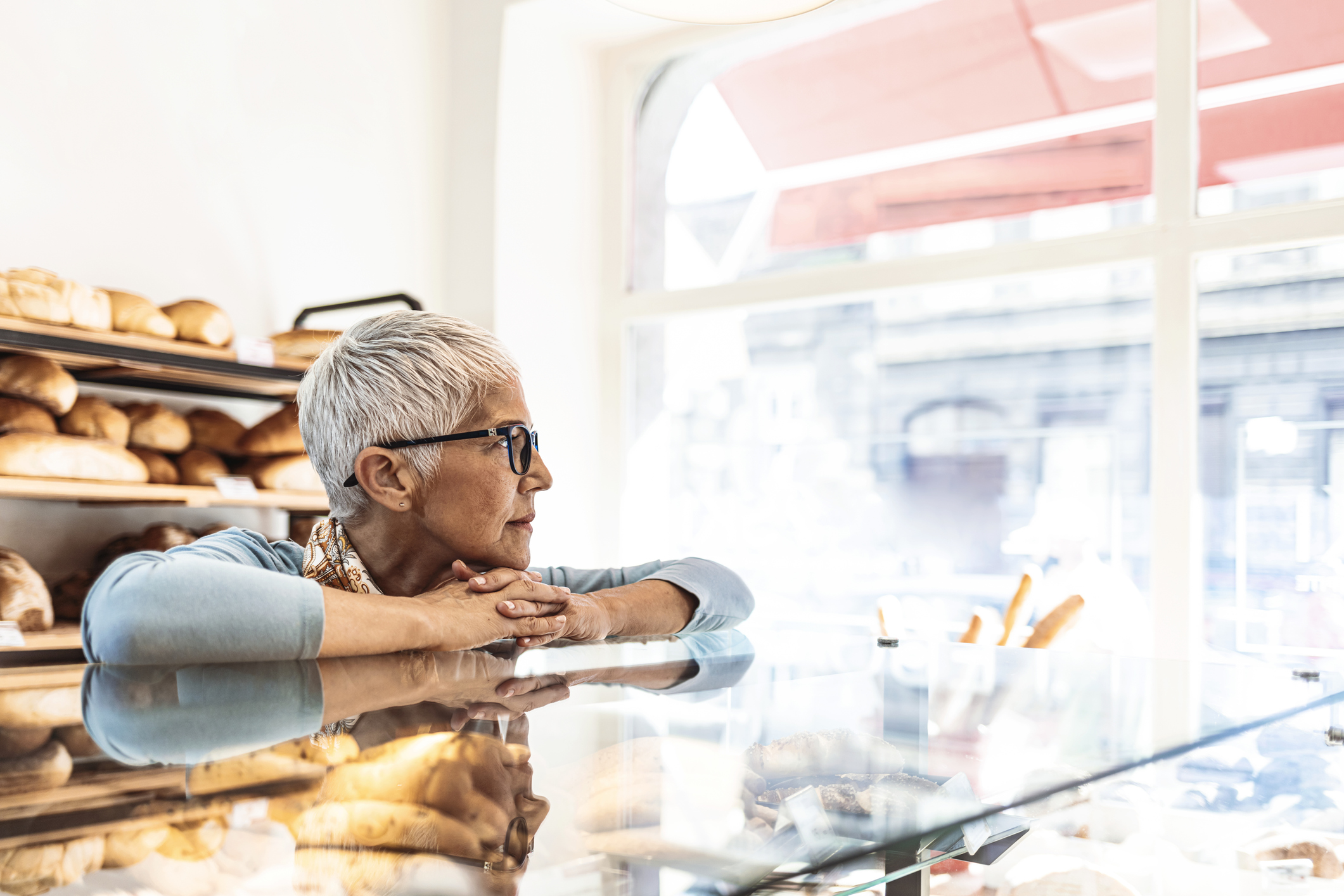 Depressed senior woman at work feeling sad