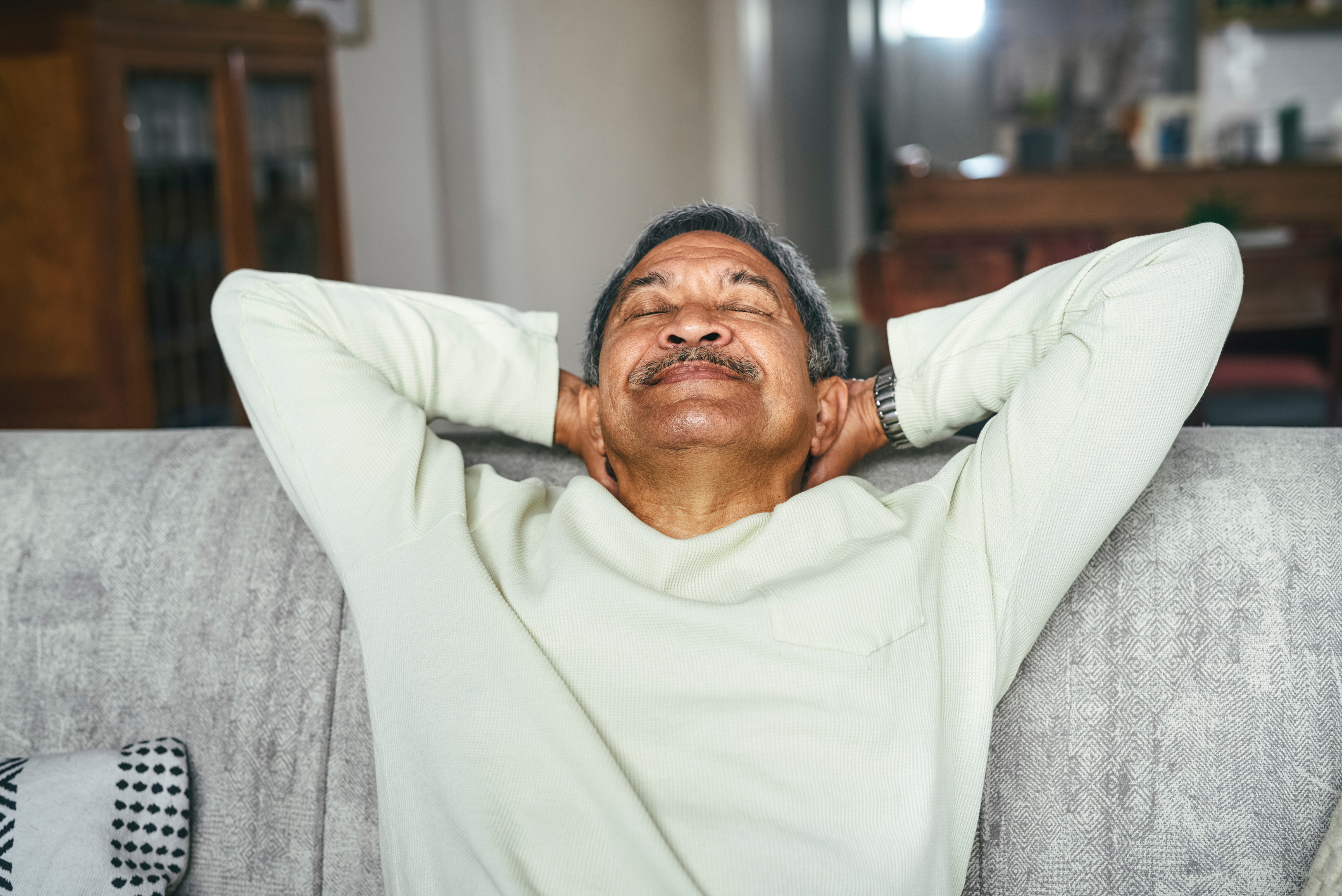 Shot of a happy senior man relaxing on the sofa at home