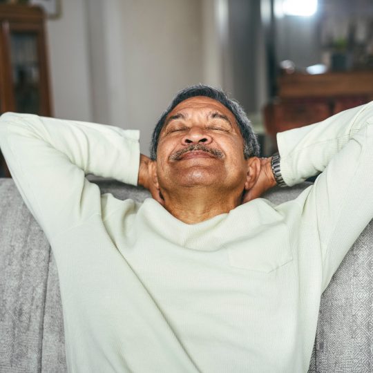 Shot of a happy senior man relaxing on the sofa at home