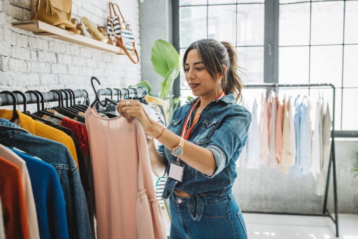 Ethnic small business owner smiling cheerfully in her shop