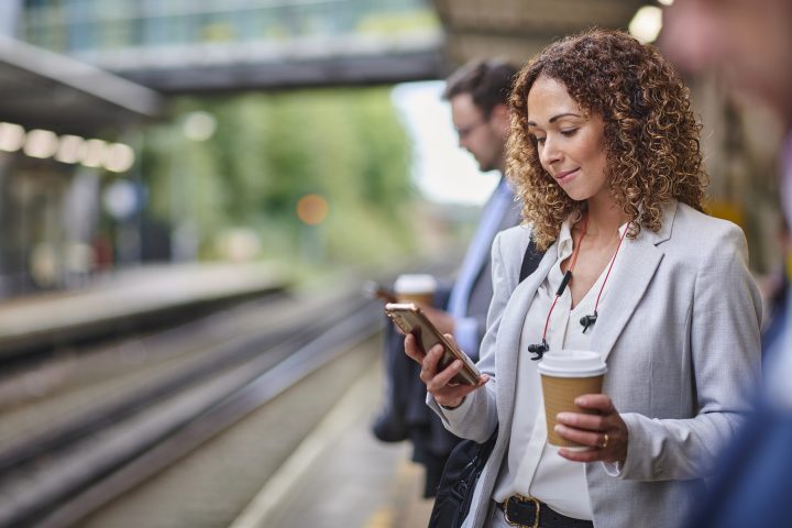 Woman in business attire looking at phone