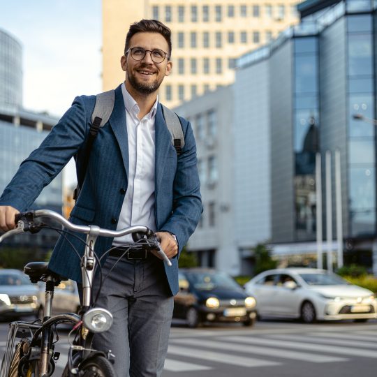 a man walking with his bike in a city
