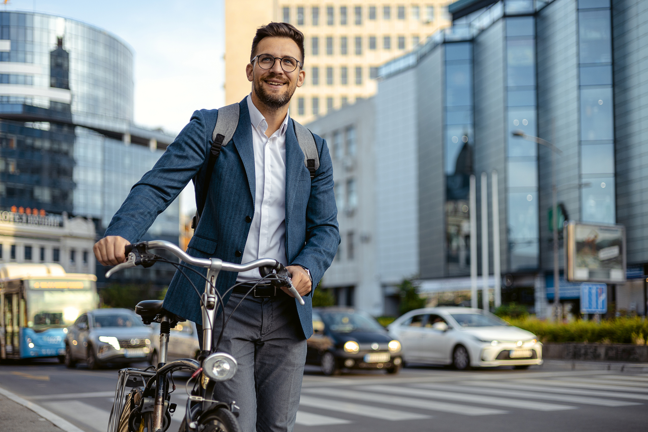 a man walking with his bike in a city
