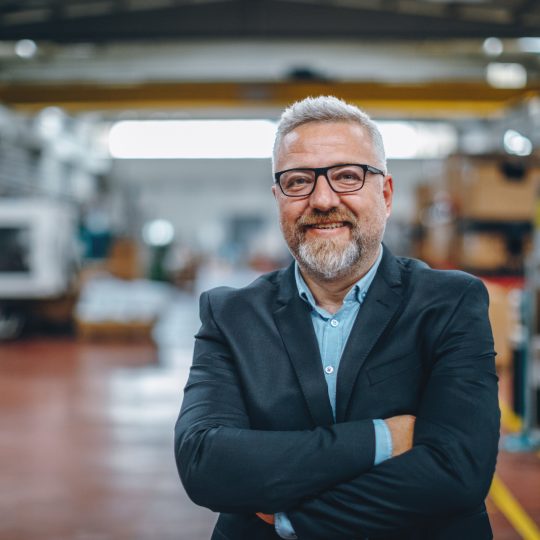 Portrait of Smiling Senior Manager Businessman or CEO in Industrial Factory