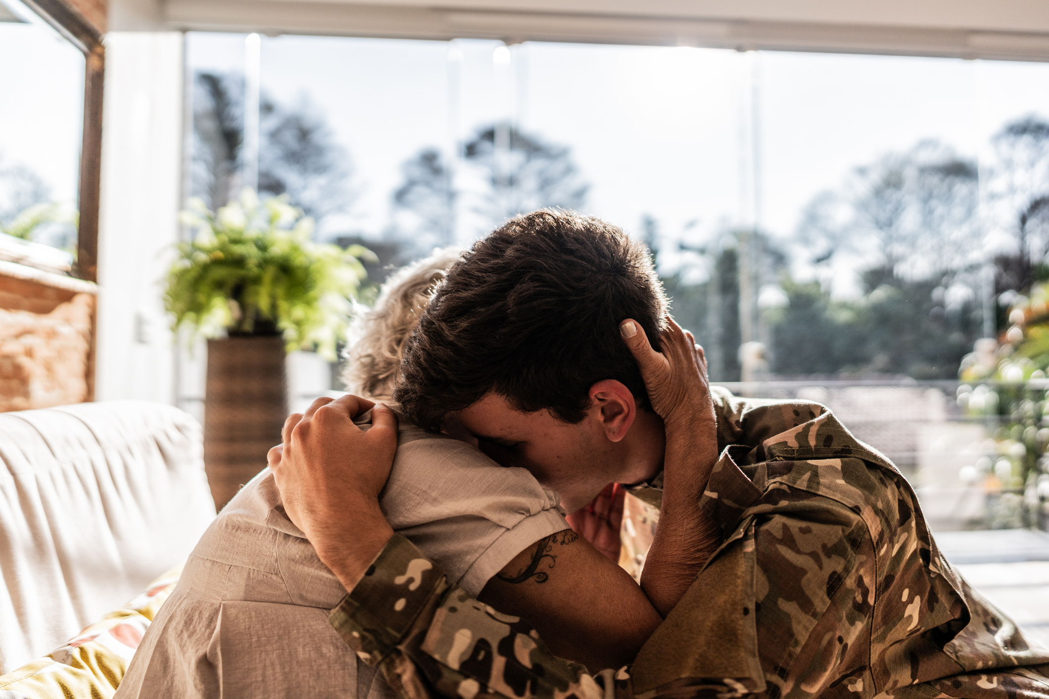 Army soldier embracing his grandmother at home