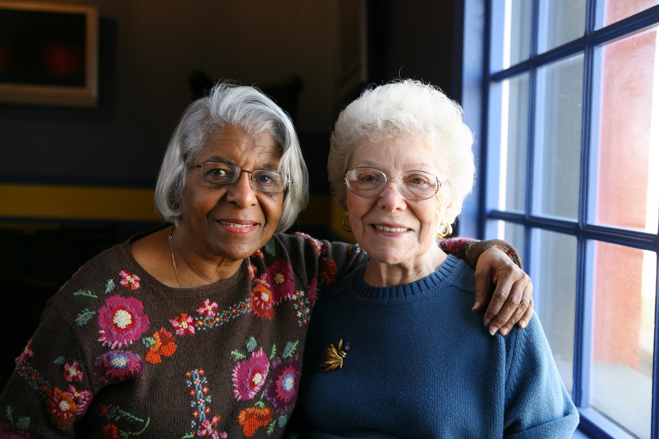 Image of two senior woman smiling towards the camera
