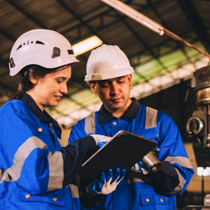 Man and woman professional robot engineer work together