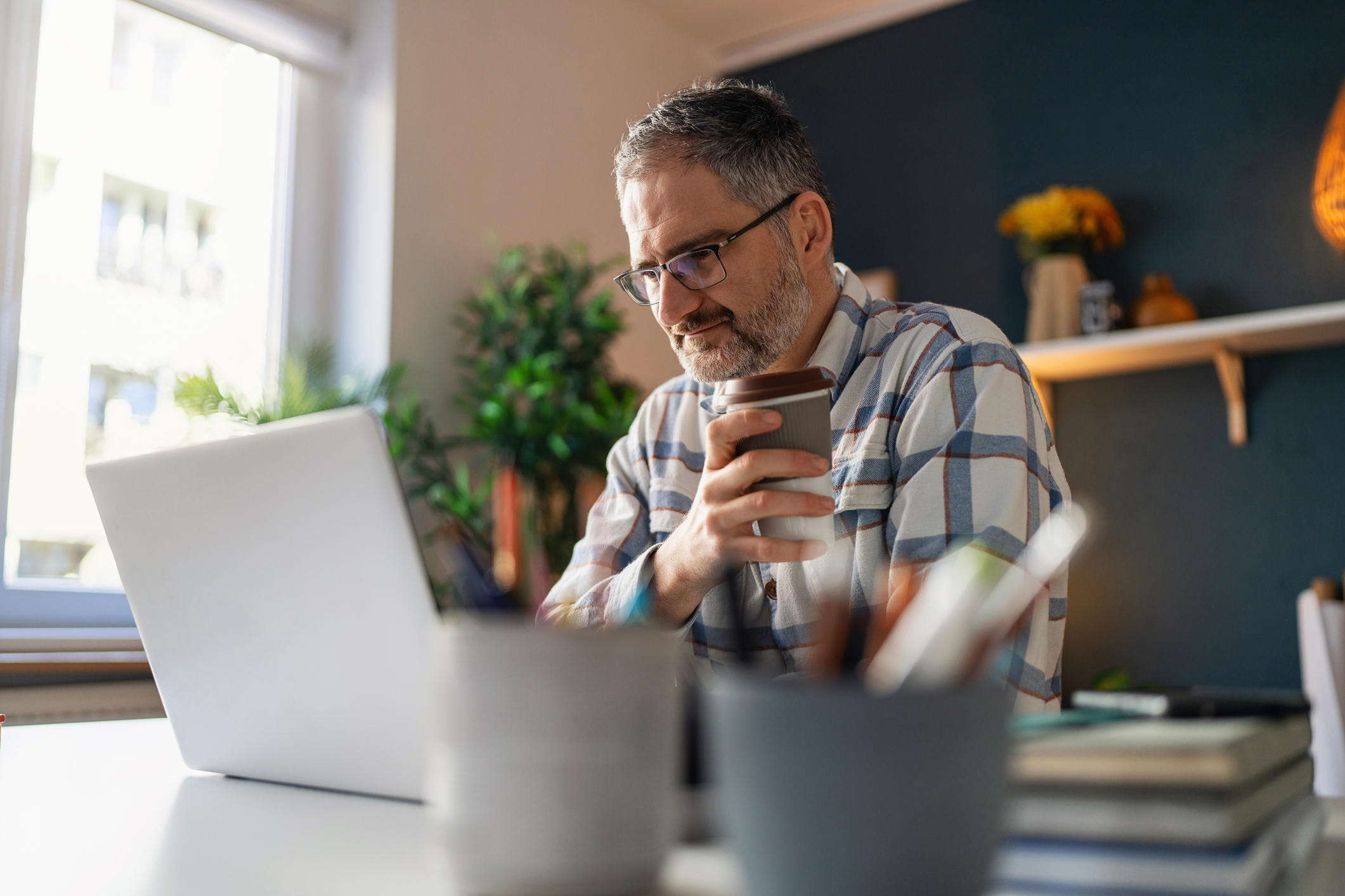 man drinking coffee while working from home