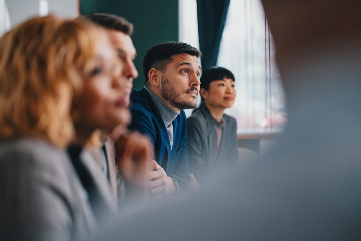 A wide angle view of a Caucasian entrepreneur at a business meeting