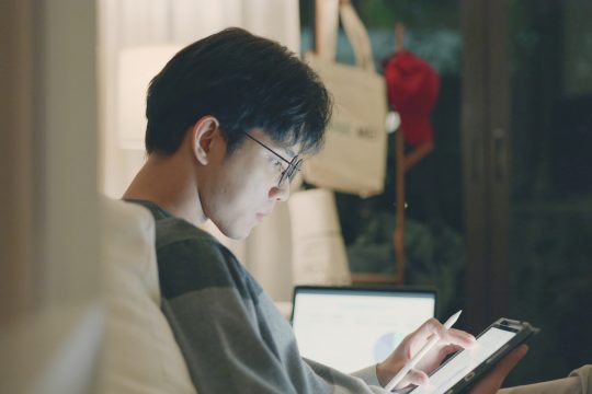 Focused Businessman Analyzing Data on Tablet