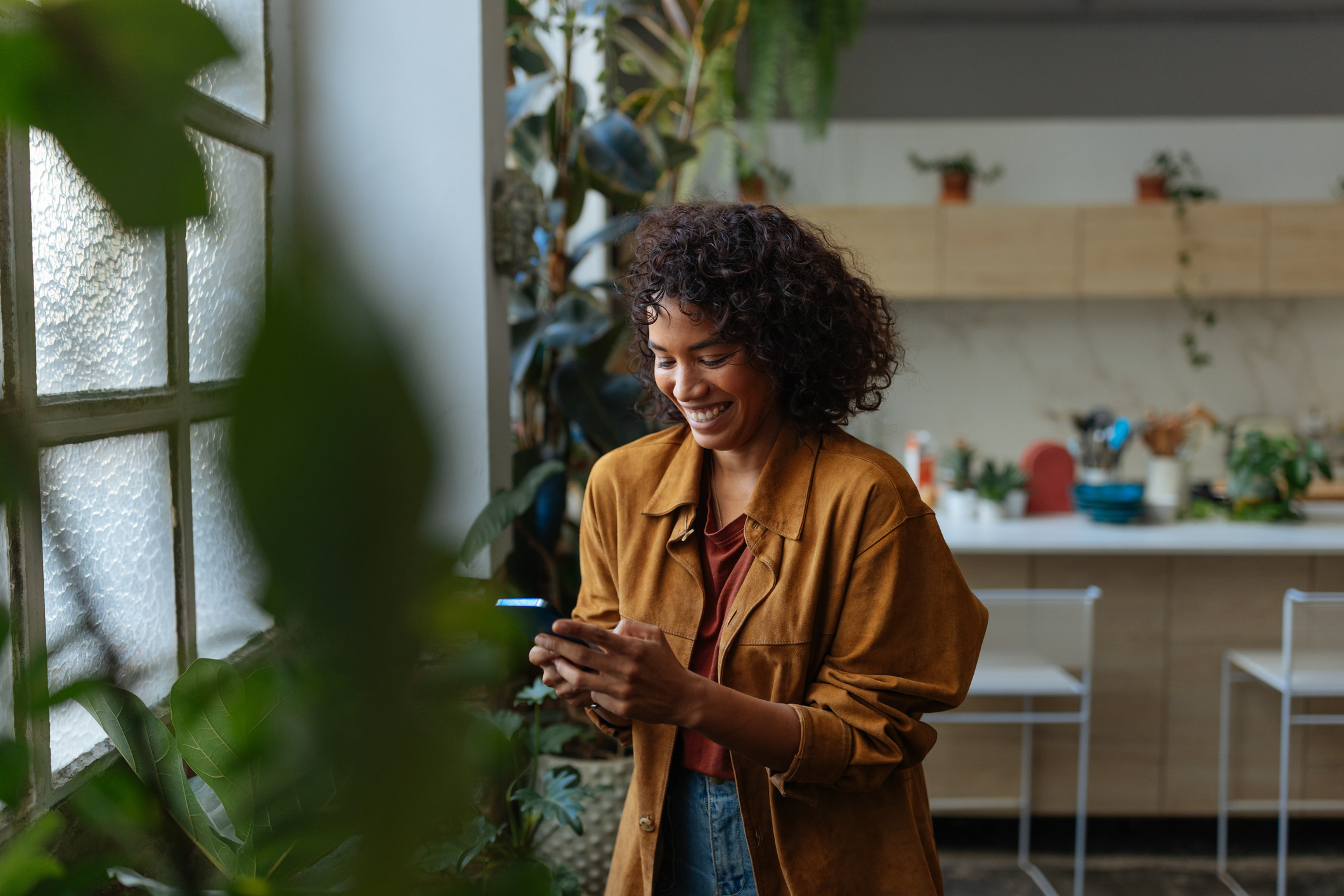 Happy young woman using her smartphone