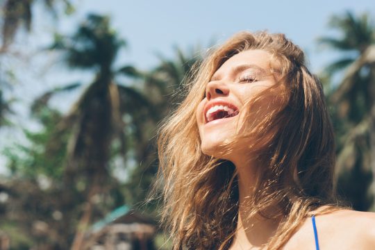 Happy woman enjoying summer outdoors