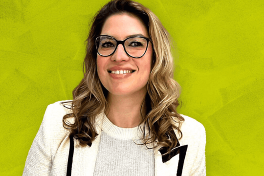 Woman in business attire smiling