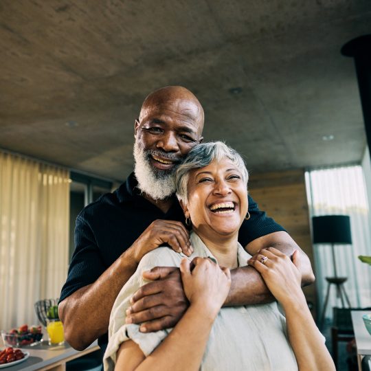 Active Retired African-American Couple Sharing a Laugh in Modern Home Kitchen