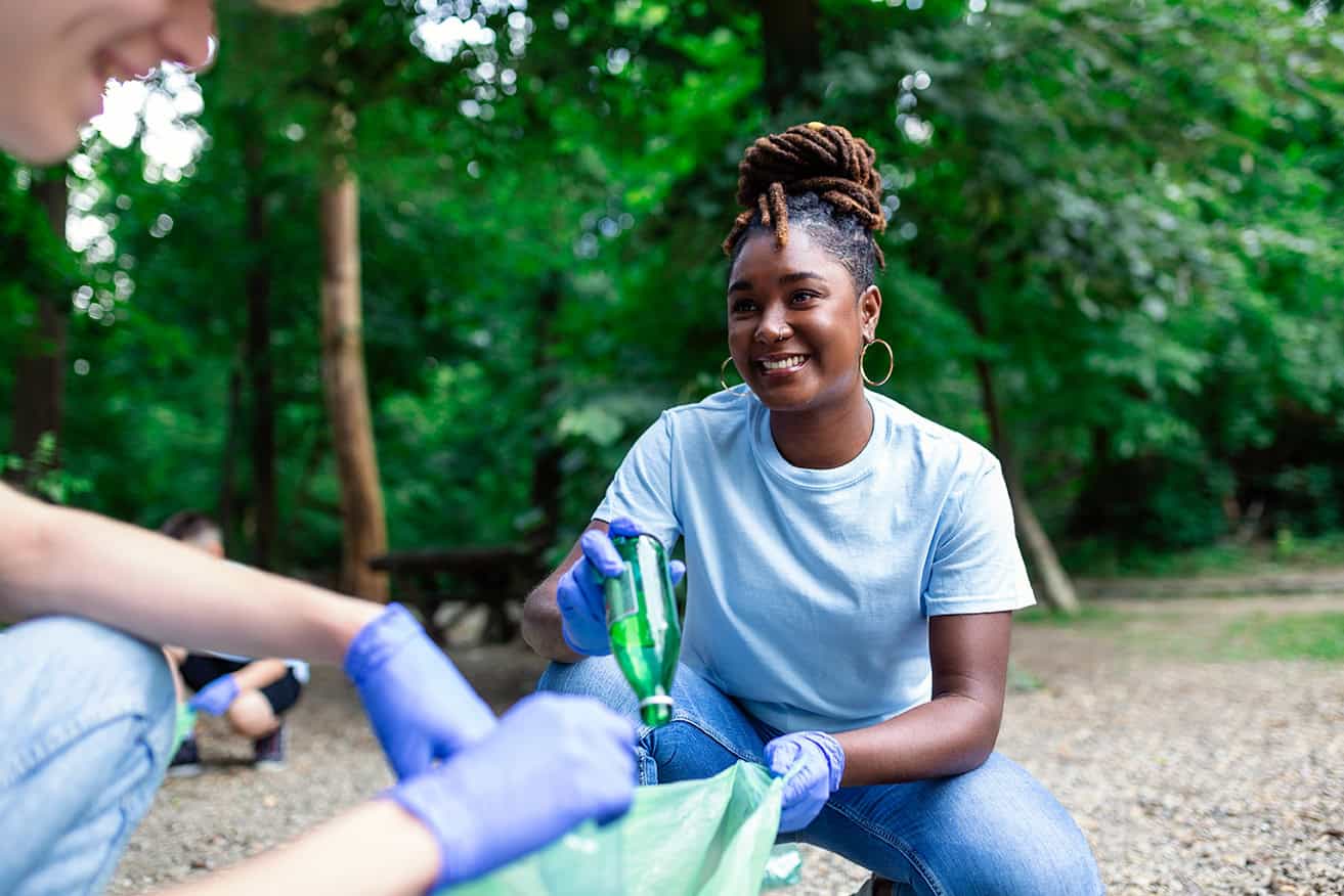 Woman litter picking at a forest