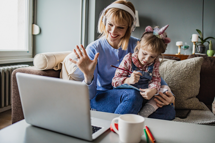 Mother and daughter look at laptop