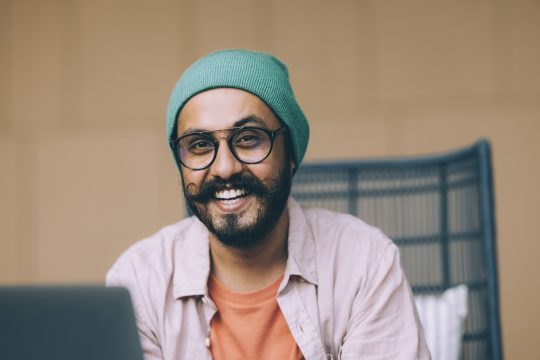 A Handsome Bearded Businessman Smiling While Looking At Camera