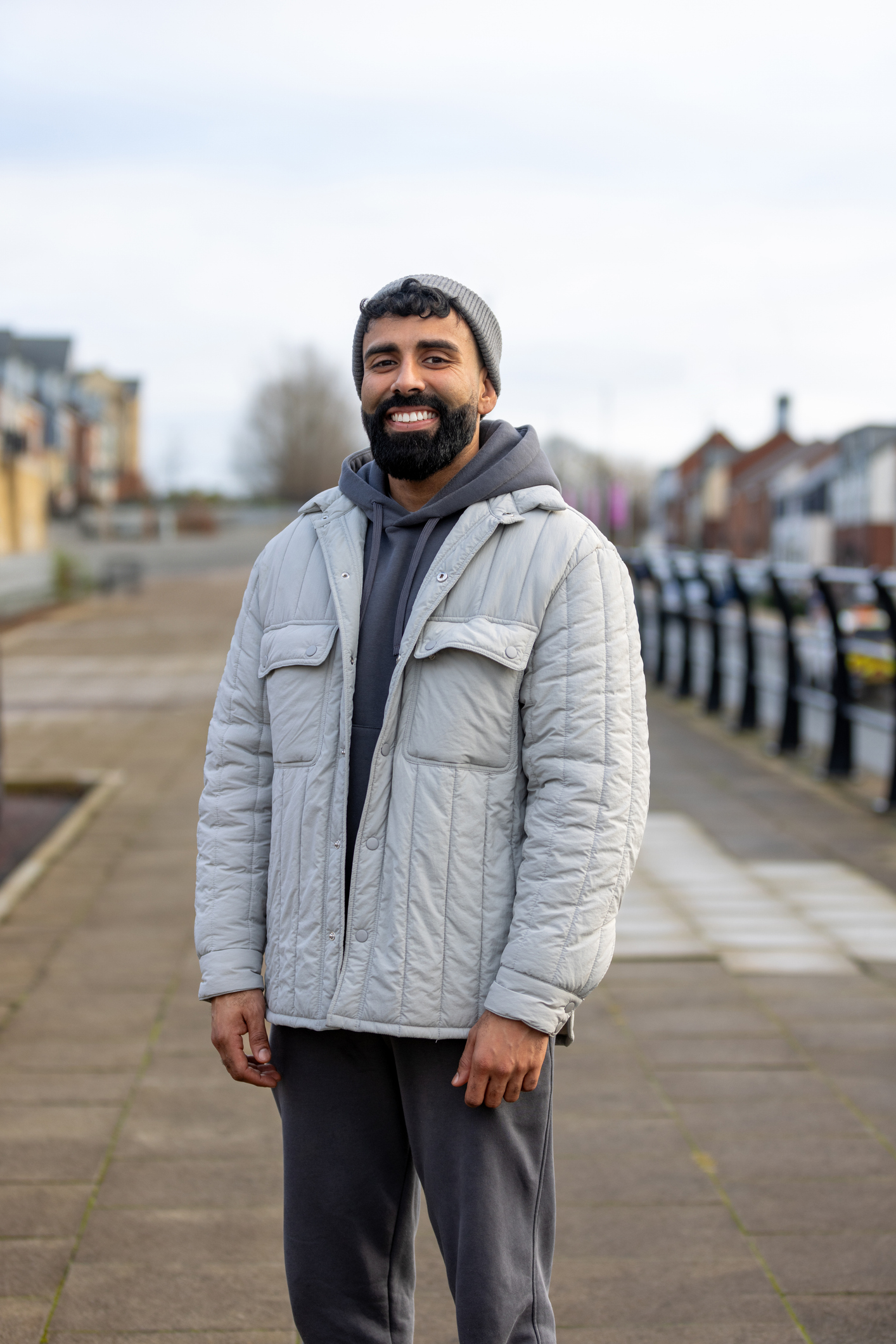 image of man wearing grey jacket smiling
