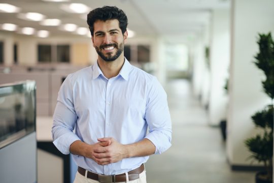 A man standing in a company office.