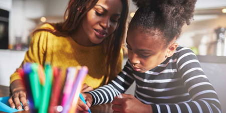 woman with little girl doing homework