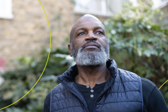 Man stands in front of house