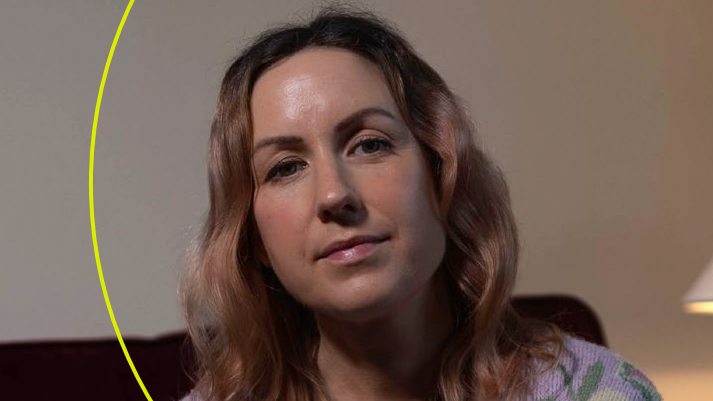 Woman sits in lounge with green circle behind.
