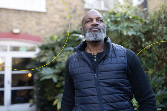 man in blue vest looking up